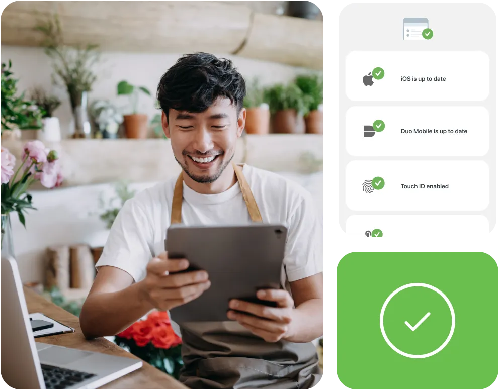 A person smiling and looking at successful authentications on his tablet.