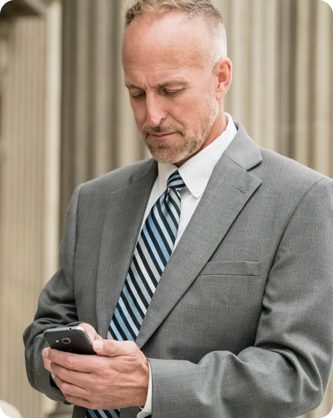 Government employee looking at their mobile phone with advanced identity protection from Duo Federal Advantage.