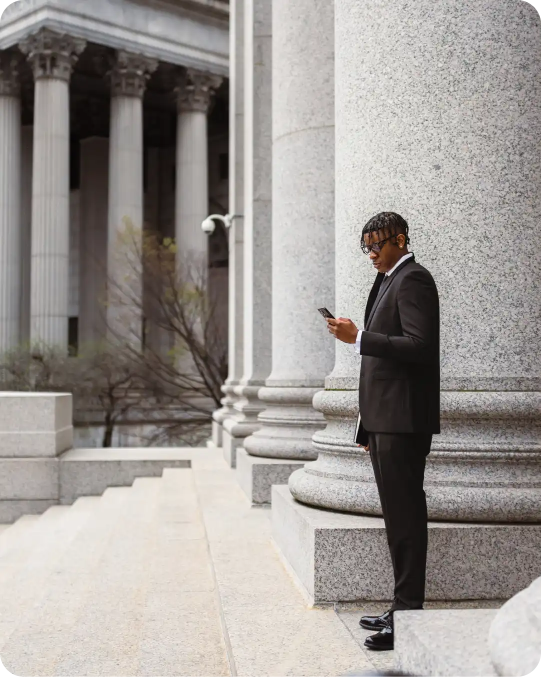 Government worker looking at their mobile device for their government agency protected by federal-grade authentication from Duo.