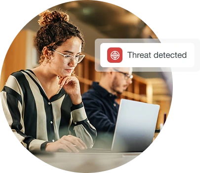 Women checking the laptop and a threat is detected.