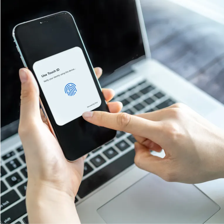 Person using Touch ID on a smartphone with a verification prompt