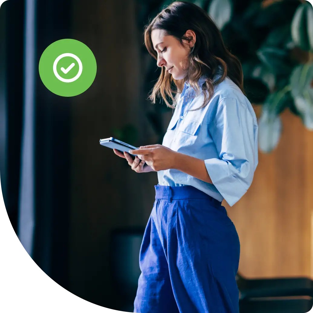 Professional reviewing device access in a modern office, representing how authorization controls user permissions in enterprise security systems.