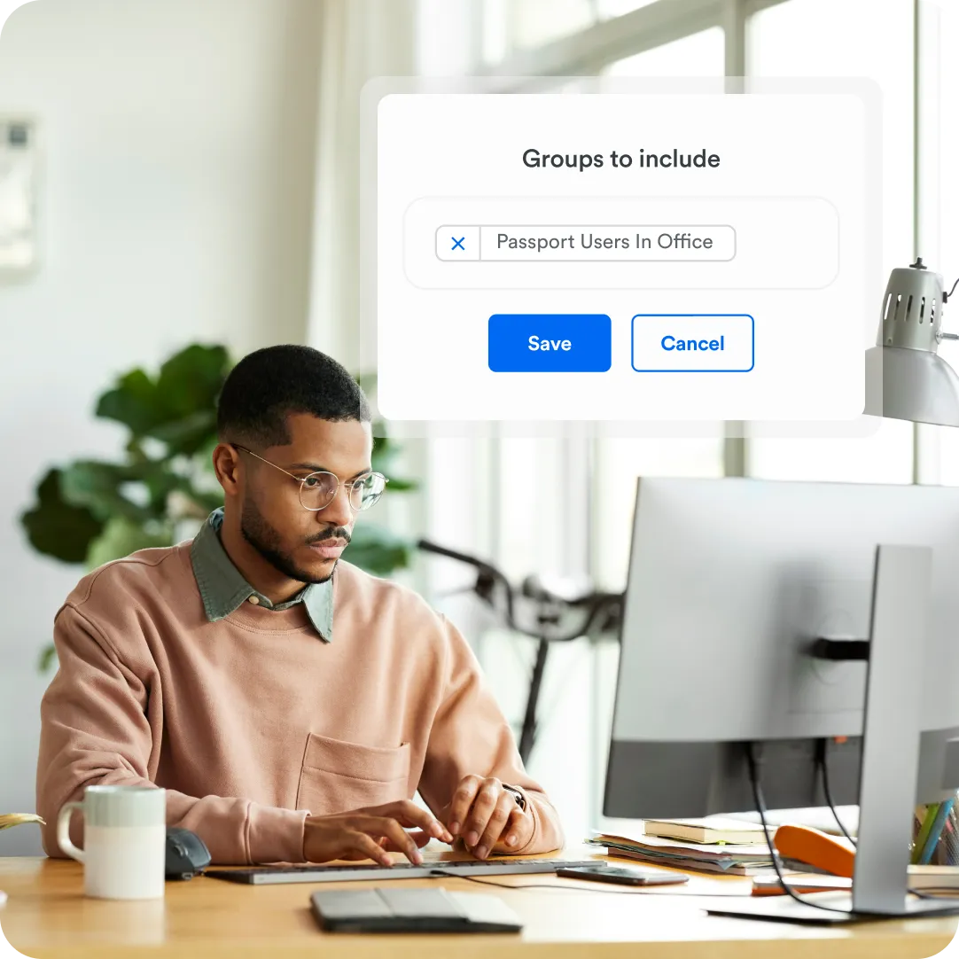Professional sitting at desk giving permission security access to their team with Duo Passport.