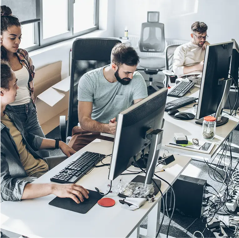 Four professional workers using Duo's identity security solutions for remote access in an office setting