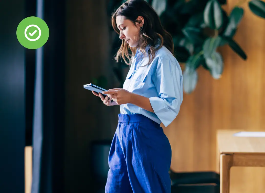 Professional reviewing device access in a modern office, representing how authorization controls user permissions in enterprise security systems.