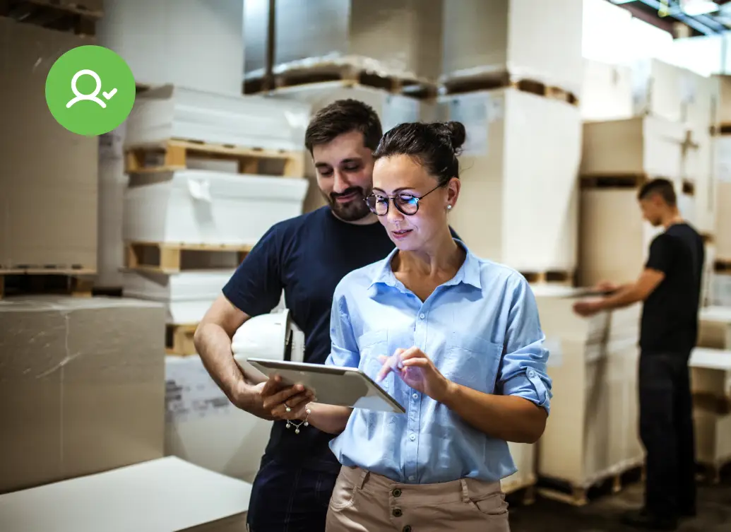 A business professional reviewing customer data on a tablet