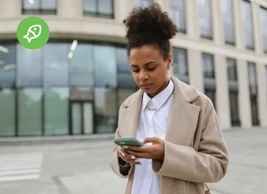 Woman holding a mobile device with a concerned expression, illustrating the impact of a phishing attack on everyday users