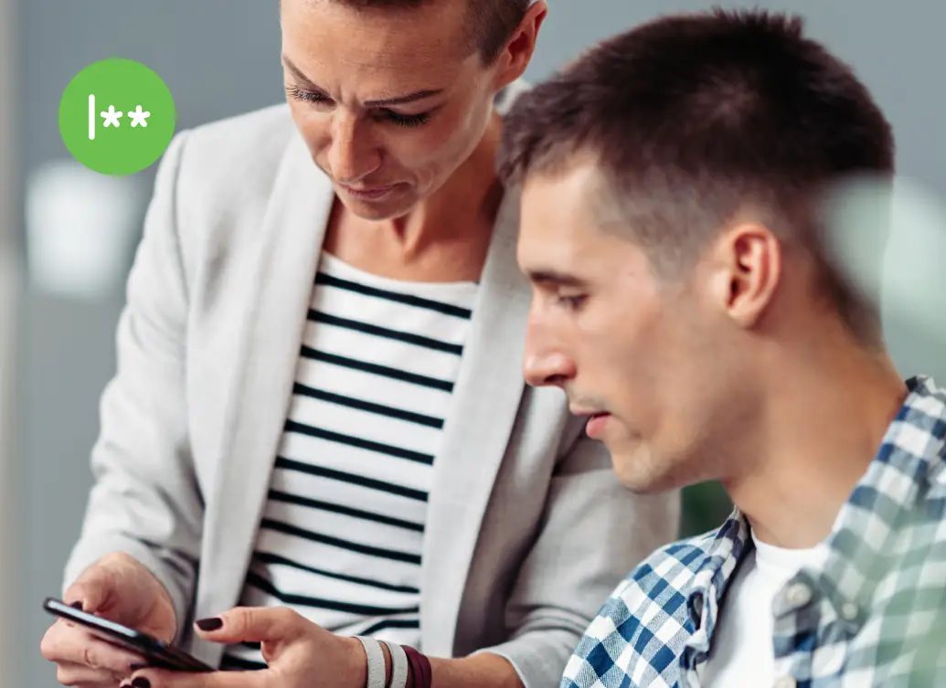 Two IT professionals reviewing SSH access authentication on a mobile device