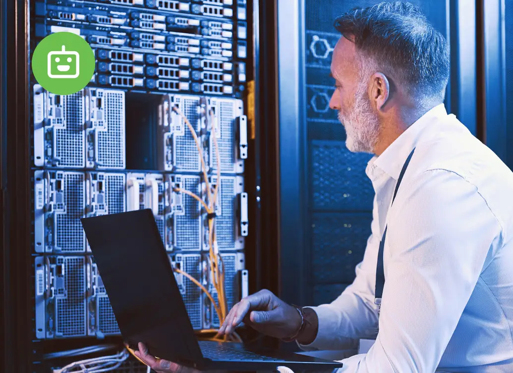 IT professional working on a laptop in a server room, managing non-human identity and machine access across enterprise infrastructure