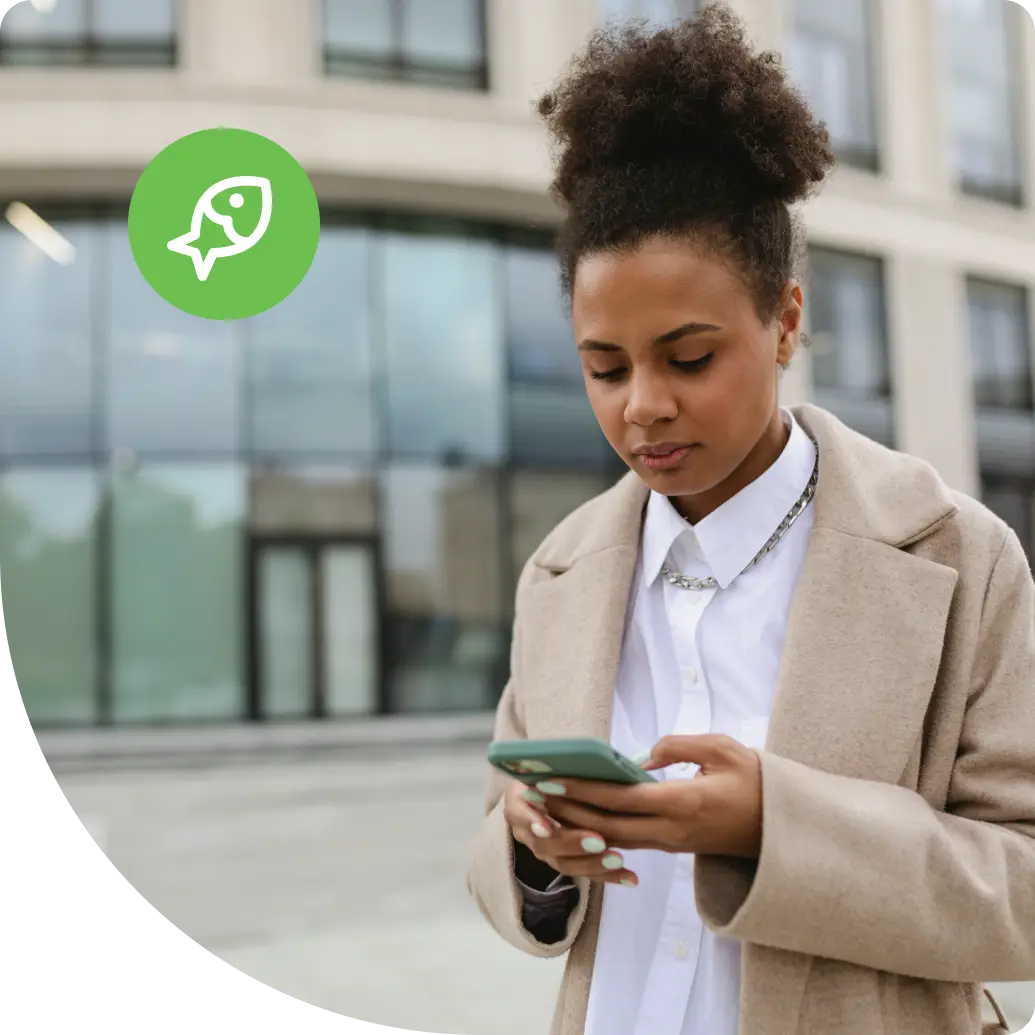 Woman holding a mobile device with a concerned expression, illustrating the impact of a phishing attack on everyday users