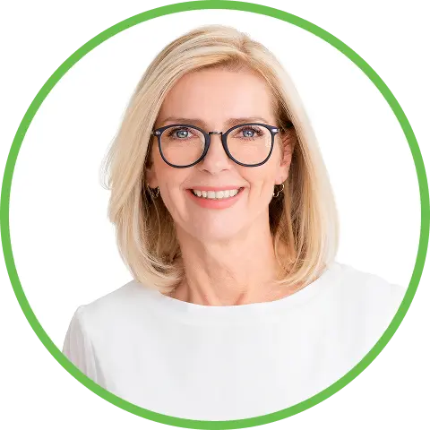 Smiling woman with blonde hair, glasses, and a white top.